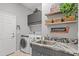 Modern laundry room with washer, dryer, and granite countertop at 2305 Little Country Rd, Parrish, FL 34219