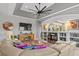 Bright living room featuring sectional sofa, built-in shelving, and high ceilings at 2305 Little Country Rd, Parrish, FL 34219