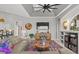 Relaxing living room with sectional sofa, built-in shelving, and large TV at 2305 Little Country Rd, Parrish, FL 34219