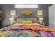 Main bedroom with a floral comforter and accent pillows at 2305 Little Country Rd, Parrish, FL 34219