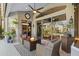 Covered patio with fire pit and comfortable seating at 2305 Little Country Rd, Parrish, FL 34219