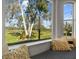 Window seat overlooking a tranquil lake and lush landscape at 2305 Little Country Rd, Parrish, FL 34219