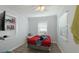 Small bedroom with red bedspread and built-in shelving at 2825 Forest Ln, Sarasota, FL 34231