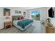 Main bedroom with ocean views, a king-size bed, and coastal decor at 3017 Avenue E, Holmes Beach, FL 34217