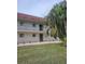 Well-maintained condo building with green lawn and palm trees at 3500 Beneva Rd # 303, Sarasota, FL 34232