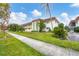 Building exterior showcasing landscaping and parking at 3500 Beneva Rd # 303, Sarasota, FL 34232