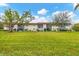 Building exterior with green lawn and mature trees at 3500 Beneva Rd # 303, Sarasota, FL 34232