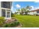 Building exterior showcasing lush landscaping and lawn at 3500 Beneva Rd # 303, Sarasota, FL 34232