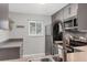 Modern kitchen with gray cabinets and stainless steel appliances at 3500 Beneva Rd # 303, Sarasota, FL 34232