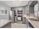 Updated kitchen featuring gray cabinets and tile backsplash at 3500 Beneva Rd # 303, Sarasota, FL 34232
