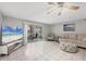 Living room featuring a large TV and access to a patio at 3500 Beneva Rd # 303, Sarasota, FL 34232