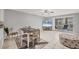 Living room with dining area, access to patio, and a large TV at 3500 Beneva Rd # 303, Sarasota, FL 34232
