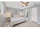 Main bedroom with king-size bed, ceiling fan, and ensuite bathroom access at 3500 Beneva Rd # 303, Sarasota, FL 34232