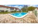 Inviting community pool with brick patio and surrounding landscaping at 3500 Beneva Rd # 303, Sarasota, FL 34232