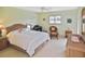 Bright bedroom with a comfortable bed and wicker furniture at 365 Three Lakes Ln # G, Venice, FL 34285