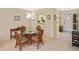 Condo dining area with round glass table and wicker chairs at 365 Three Lakes Ln # G, Venice, FL 34285