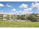Community features a serene lake with lush landscaping at 365 Three Lakes Ln # G, Venice, FL 34285