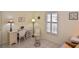 Well-lit home office with wicker chairs and window seating at 365 Three Lakes Ln # G, Venice, FL 34285