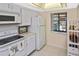 Bright condo kitchen with white cabinets and appliances at 365 Three Lakes Ln # G, Venice, FL 34285