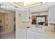 Condo kitchen features white cabinets and a pass-through to the living area at 365 Three Lakes Ln # G, Venice, FL 34285