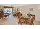 Condo living area with patio view, wicker furniture and a dining area at 365 Three Lakes Ln # G, Venice, FL 34285