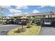 Condo complex with carport parking and lush landscaping at 365 Three Lakes Ln # G, Venice, FL 34285