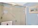 Shower with glass enclosure and tiled walls at 365 Three Lakes Ln # G, Venice, FL 34285