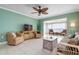 Living room with water view, wicker furniture and ceiling fan at 3861 Catalina Dr, Bradenton, FL 34210