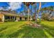 Spacious backyard with grassy lawn and partial house view at 4045 Oakhurst Dr # 3125, Sarasota, FL 34233