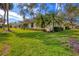 Large backyard, grassy lawn, and partial house view at 4045 Oakhurst Dr # 3125, Sarasota, FL 34233