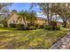 House with palm trees and manicured lawn at 4045 Oakhurst Dr # 3125, Sarasota, FL 34233