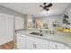 Modern kitchen with white cabinetry, stainless steel sink, and a breakfast bar at 4045 Oakhurst Dr # 3125, Sarasota, FL 34233