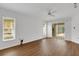 Bright living room with wood-look floors and sliding glass doors leading to patio at 407 68Th Avenue W Dr, Bradenton, FL 34207