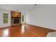 Bright living room with hardwood floors, fireplace, and sliding glass doors at 407 68Th Avenue W Dr, Bradenton, FL 34207