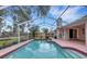 Sparkling screened pool with a large patio and lush greenery at 407 68Th Avenue W Dr, Bradenton, FL 34207