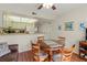 Dining area with round table and chairs, view to kitchen and living room at 425 30Th W Ave # C206, Bradenton, FL 34205