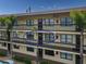 Condo building exterior with balconies and palm trees at 425 30Th W Ave # C206, Bradenton, FL 34205