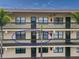 Condo building exterior featuring balconies and palm trees at 425 30Th W Ave # C206, Bradenton, FL 34205