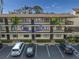 Condo building exterior with parking and balconies at 425 30Th W Ave # C206, Bradenton, FL 34205