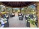 Covered gazebo with wicker furniture overlooking a lake at 425 30Th W Ave # C206, Bradenton, FL 34205