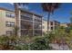 Condo building exterior with tropical plants at 425 30Th W Ave # C206, Bradenton, FL 34205