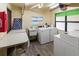 Shared laundry room with washers, dryers, and folding table at 425 30Th W Ave # C206, Bradenton, FL 34205