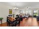 Bright living room with hardwood floors, dining area, and view to patio at 425 30Th W Ave # C206, Bradenton, FL 34205