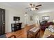 Living room with hardwood floors, ceiling fan and access to other rooms at 425 30Th W Ave # C206, Bradenton, FL 34205