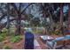 Peaceful lake view from a patio with grill and seating area at 425 30Th W Ave # C206, Bradenton, FL 34205