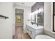 Elegant bathroom with double vanity and view to bedroom at 4497 N Salford Blvd, North Port, FL 34286