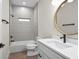 Modern bathroom featuring a soaking tub, vanity, and stylish fixtures at 4497 N Salford Blvd, North Port, FL 34286