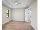 Bright bedroom with wood-look floors and ceiling fan at 4497 N Salford Blvd, North Port, FL 34286