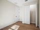 Simple bedroom with wood-look floors and a closet at 4497 N Salford Blvd, North Port, FL 34286