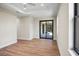 Spacious bedroom with wood-look floors and sliding glass doors to patio at 4497 N Salford Blvd, North Port, FL 34286